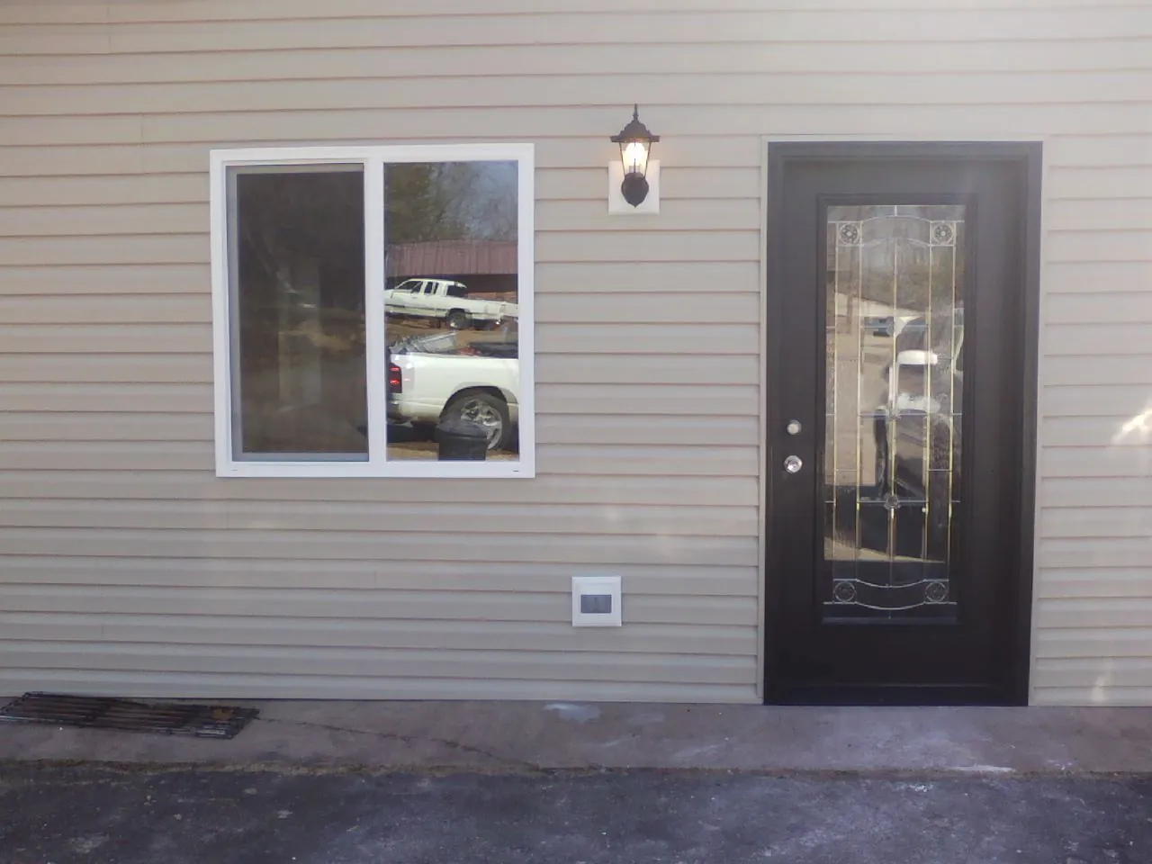 New siding, window and entry door on the side of an addition in Eudora
